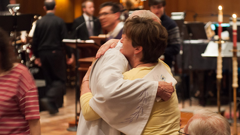 Two people hugging at church